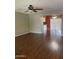 Bright living room featuring sleek, dark hardwood floors and natural lighting at 11001 W Tonada Dr, Sun City, AZ 85351