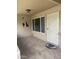 Covered patio featuring tile flooring, a secure door and wall decor at 11001 W Tonada Dr, Sun City, AZ 85351