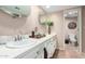 Bathroom featuring dual sinks, a large mirror, and lots of counter space at 115 E Piping Rock Rd, Phoenix, AZ 85022