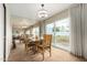 Bright dining room with a light fixture, large windows, and a view to the backyard at 115 E Piping Rock Rd, Phoenix, AZ 85022