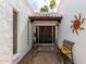 Inviting tiled entryway with decorative art, rustic bench, and beautiful double doors at 115 E Piping Rock Rd, Phoenix, AZ 85022