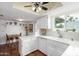 Kitchen view with white cabinets and appliances, as well as saltillo tile flooring at 115 E Piping Rock Rd, Phoenix, AZ 85022