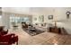 Spacious living room featuring neutral tones, a large window, and comfortable furnishings at 115 E Piping Rock Rd, Phoenix, AZ 85022