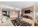 Spacious living room featuring neutral tones, tile accents, and comfortable furnishings at 115 E Piping Rock Rd, Phoenix, AZ 85022