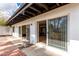 View of outdoor patio with sliding glass doors leading to interior spaces, offering seamless indoor-outdoor living at 115 E Piping Rock Rd, Phoenix, AZ 85022