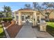 Exterior view of the community space featuring a tile gazebo, picnic table, and stainless steel grill at 12221 W Bell Rd # 215, Surprise, AZ 85378