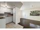 Bright kitchen with white cabinetry blends into the living area, offering a cohesive and modern living space at 12221 W Bell Rd # 215, Surprise, AZ 85378