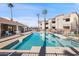 Relax by the community pool with comfortable seating and views of the surrounding buildings at 12221 W Bell Rd # 215, Surprise, AZ 85378