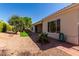 Serene backyard featuring desert landscaping and a covered patio, ideal for relaxing and outdoor entertaining at 12820 W La Vina Dr, Sun City West, AZ 85375