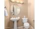 A well-lit half bathroom showing a pedestal sink and toilet at 12820 W La Vina Dr, Sun City West, AZ 85375