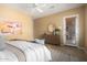 A spacious bedroom featuring a dresser, abstract art, and a door to the backyard at 12820 W La Vina Dr, Sun City West, AZ 85375