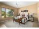 A naturally lit bedroom with a large window, neutral colors, and a modern ceiling fan at 12820 W La Vina Dr, Sun City West, AZ 85375