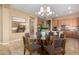 Breakfast nook with a unique glass table and views of the kitchen and living areas at 12820 W La Vina Dr, Sun City West, AZ 85375