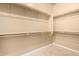 Spacious walk-in closet with built-in shelving and ample storage space at 12820 W La Vina Dr, Sun City West, AZ 85375