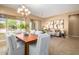 Open concept dining area with wood table, white chairs, and bright natural light at 12820 W La Vina Dr, Sun City West, AZ 85375