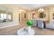 Open-concept dining room featuring a stylish chandelier and seamless access to other living spaces at 12820 W La Vina Dr, Sun City West, AZ 85375