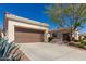 Exterior view of a single-story home showcasing an attached two-car garage and concrete driveway at 12820 W La Vina Dr, Sun City West, AZ 85375