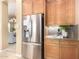 A kitchen with stainless steel refrigerator and a view into another room of the house at 12820 W La Vina Dr, Sun City West, AZ 85375