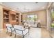 Bright living room features a built-in display, neutral tones, and access to the patio at 12820 W La Vina Dr, Sun City West, AZ 85375