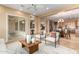 Open-concept living room flows into dining area; featuring neutral palette and sliding glass doors at 12820 W La Vina Dr, Sun City West, AZ 85375