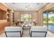 Bright living room featuring neutral walls, built-in shelving, and large windows overlooking the backyard at 12820 W La Vina Dr, Sun City West, AZ 85375