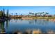 Scenic pond with lush landscaping and serene water views, enhancing the natural beauty of the community at 12820 W La Vina Dr, Sun City West, AZ 85375