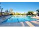 Resort-style pool with lap lanes, lounge chairs, and shaded seating areas at 12820 W La Vina Dr, Sun City West, AZ 85375