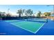 Well-maintained tennis court with lighting for evening play at 12820 W La Vina Dr, Sun City West, AZ 85375