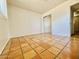 Bedroom features terracotta tiled flooring and mirrored closet doors at 1337 W Elna Rae St, Tempe, AZ 85281