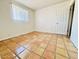 Bright bedroom features terracotta tiled flooring and a window at 1337 W Elna Rae St, Tempe, AZ 85281