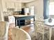 Eat-in kitchen featuring white cabinets, a blue kitchen island, and stainless steel appliances at 1337 W Elna Rae St, Tempe, AZ 85281