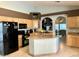 Kitchen featuring an island with granite countertop and modern black appliances at 14240 N Ibsen Dr # B, Fountain Hills, AZ 85268