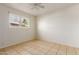 Bright bedroom with tile flooring and a window for natural light at 1427 W 6Th Dr, Mesa, AZ 85202