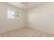 Bright bedroom features a ceiling fan and window providing natural light at 1427 W 6Th Dr, Mesa, AZ 85202