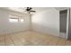 This bedroom boasts neutral decor and durable tile flooring, offering a cozy retreat within the home at 1427 W 6Th Dr, Mesa, AZ 85202