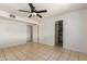 A neutrally decorated bedroom showcases ample space with a ceiling fan, providing a blank canvas for personal touches at 1427 W 6Th Dr, Mesa, AZ 85202