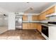 A bright kitchen features ample cabinet space, a stainless steel fridge and durable tile flooring at 1427 W 6Th Dr, Mesa, AZ 85202