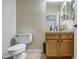 Bathroom featuring a toilet, vanity with wood cabinets and a neutral countertop at 150 N Lakeview Blvd # 1, Chandler, AZ 85225