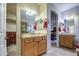 Dual vanities, tile floors and countertops are featured in this well-lit bathroom at 150 N Lakeview Blvd # 1, Chandler, AZ 85225