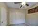 Neutral bedroom with carpet flooring, shuttered windows, and a ceiling fan at 150 N Lakeview Blvd # 1, Chandler, AZ 85225