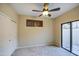 Bedroom with white closet doors and a glass sliding door to the exterior at 150 N Lakeview Blvd # 1, Chandler, AZ 85225