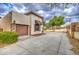 View of a driveway and garage with stone accents, complemented by a well-maintained landscape at 150 N Lakeview Blvd # 1, Chandler, AZ 85225