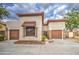 Charming home featuring a two-car garage, stone accents, and a well-manicured front yard at 150 N Lakeview Blvd # 1, Chandler, AZ 85225