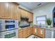 Modern Kitchen with stainless steel oven, gas range, and wood cabinetry at 150 N Lakeview Blvd # 1, Chandler, AZ 85225