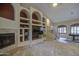 Cozy living room featuring built-in shelving, a fireplace, and staircase access at 150 N Lakeview Blvd # 1, Chandler, AZ 85225