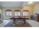 View of a naturally lit living room showcasing a decorative table and shuttered windows at 150 N Lakeview Blvd # 1, Chandler, AZ 85225