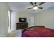 Main bedroom with carpet, ceiling fan, dresser with TV, and doorway at 150 N Lakeview Blvd # 1, Chandler, AZ 85225