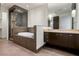 Contemporary bathroom features a bathtub, glass shower, and dark wooden cabinets at 15215 N Kierland Blvd # 633, Scottsdale, AZ 85254