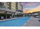 Relaxing pool area featuring lounge chairs and pergolas with a beautiful sunset backdrop at 15215 N Kierland Blvd # 633, Scottsdale, AZ 85254