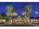 Inviting outdoor dining area at Shake Shack, surrounded by palm trees and string lights at 15215 N Kierland Blvd # 633, Scottsdale, AZ 85254